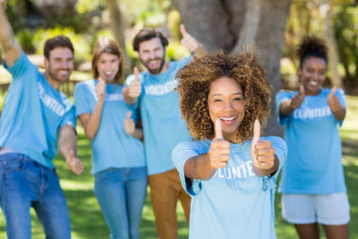 group of volunteers doing a thumbs up